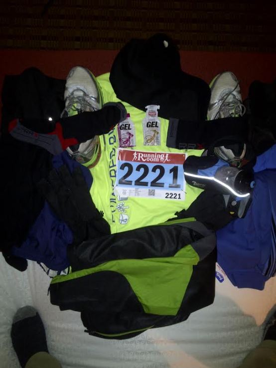 Race day gear laid on the hotel room bed.